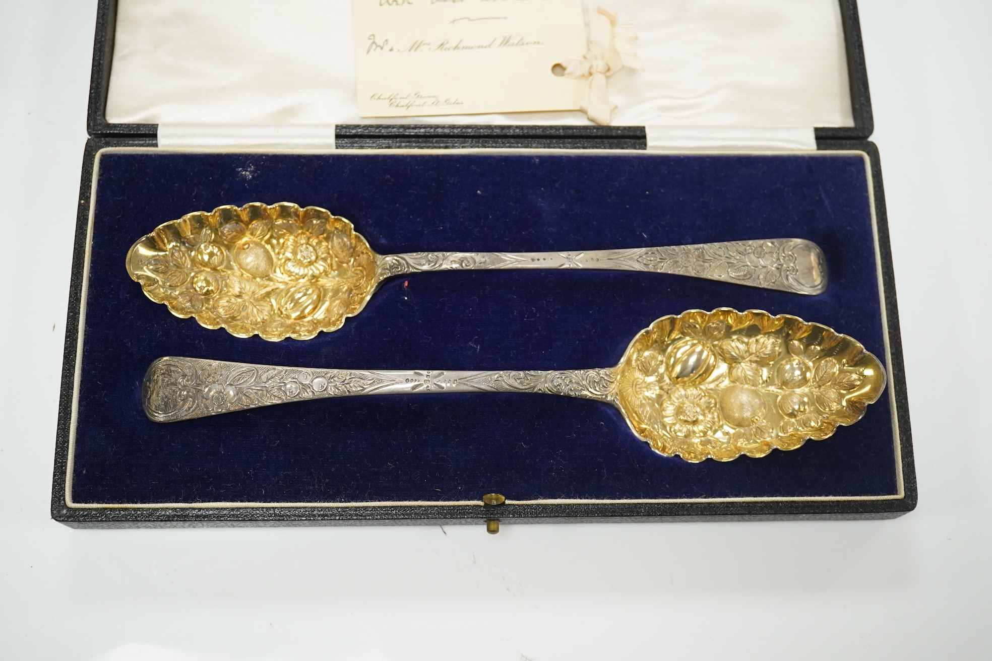 A cased 1960's three piece silver condiment set by William Suckling Ltd and and a cased pair of George III silver berry spoons, George Smith IV, London, 1812. Condition - fair